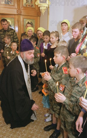 Kemerovo region, russia, january 31, 2002, father nikolai anointing with chrism young cadets (in pic) from orphanage in novokuznetsk (a city in siberia), about 20 inmates from 3 to 17 years old were baptized in home church of the vladimir icon of our lady in the city, their tutors and senior pupils became godparents for the newly converted.