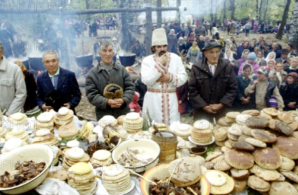 The republic of mari el (russian federation), pagans pray in the sacred kupriyanovskaya grove during a pagan holiday before sharing a common meal of boiled meat and bread, 11/95 .