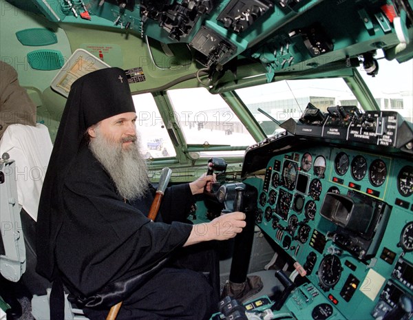 Yekaternburg, russia, april 21, 2003, archbishop of yekaterburg and verkhoturye vikenty who blessed a modernized tu-154m airliner which was purchased by the 'uralskye avialinll' airline pictured in the cockpit of the plane.