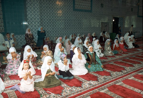 Almetyvsk, tatarstan, russia: women praying in moslem center built partly with funding from tatneft oil company.