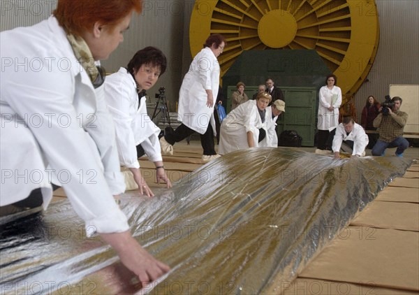 Specialists of lavochkin scientific production association are packing a part of sunlight-propelled solar sail spacecraft while preparing it for the launch, moscow region, russia, april 7, 2004.