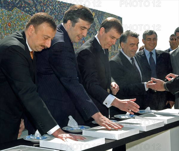 Azerbaijan, may 25, 2005, azerbaijani president ilham aliev, georgian president mikhail saakashvili and representatives of international organizations make hand prints on plaster bricks during an inauguration ceremony of the azerbaijani section of the baku-tbilisi-ceyhan international pipeline at the sangachal oil terminal, about 25 miles south of baku.