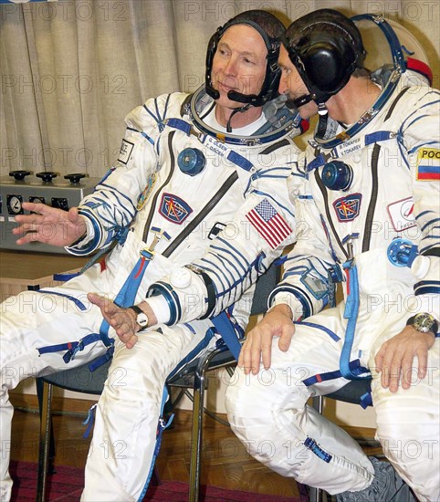 Baikonur, kazakhstan, october 1, 2005, space tourist american gregory olsen and russian flight engineer valery tokarev (from left) prior to the launching of the soyuz tma-7 spacecraft which deliver the 12th mission to the iss.