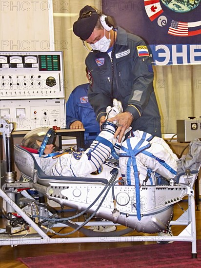 Baikonur, kazakhstan, september 18, 2006, a russian specialist checks the spacesuit of first female space tourist anousheh ansari before the launch of soyuz tma-9 rocket, which spacecraft is to take the 14th iss crew to the international space station.