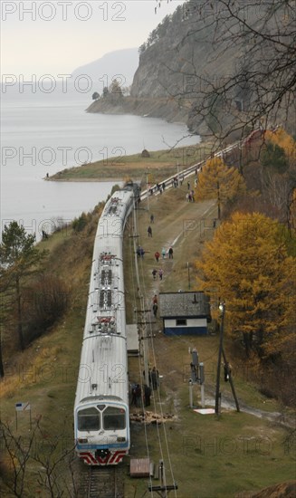 Irkutsk region, russia, commuter train stops at a station of the circular railway running along lake baikal shore, this is an old stretch of the trans-siberian railroad, november 2006.