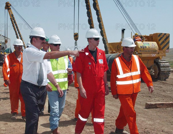 Azerbaijan, august 11, 2003, head of azerbaijan government ilkham aliyev (l) pictured visiting the construction site of the baku-ceyhan oil pipe line,on monday.
