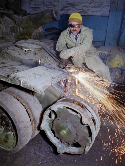 Welder sabir gadzhiyev cuts into pieces a soviet-made t-72 tank which is an item of obsolete military hardware subject to elimination under the treaty on conventional armed forces in europe, the first stage of scrapping of russian military hardware started sept,10 at the armored repair works of the grouping of russian troops in transcaucasia, tbilisi, georgia, september 10 2000.