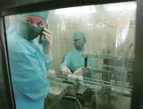 Vladimir, russia, march 28 2001: laboratory technicians svetlana uglianitsa (l) and oksana lutsenko (r), working at the anti foot-and-mouth disease vaccine pouring line