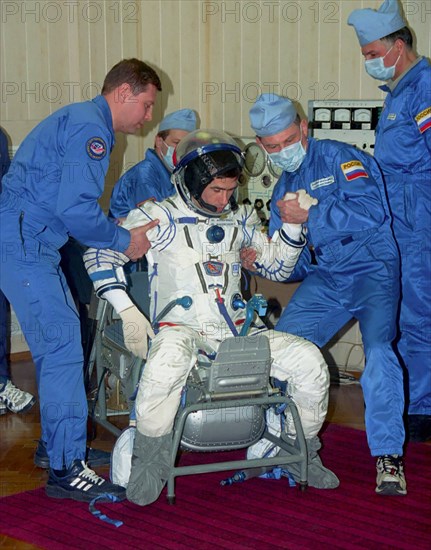 Kazakhstan, april 11, 2003, the soyuz tma-2 space crew commander colonel yuri malenchenko pictured trying on his space suit during preparation for the flight at cosmodrome baikonur, the spaceship soyuz tma-2 will be launched from the cosmodrome in april.