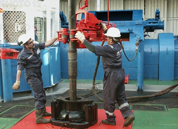 Oil drillers seen at work at lukoil's astra offshore oil rig which conducts surveying drilling of an oil-field on the caspian sea shelf, astrakhan region, russia, september 2 2003.