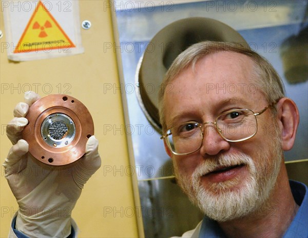 Candidate of chemical sciences, sergei shishkin holding up the plutonium target that was used in a recent research carried out at the joint institute for nuclear research to confirm the chemical composition of the newly-discovered 112th element of the periodic table, dubna, russia, may 31, 2006.