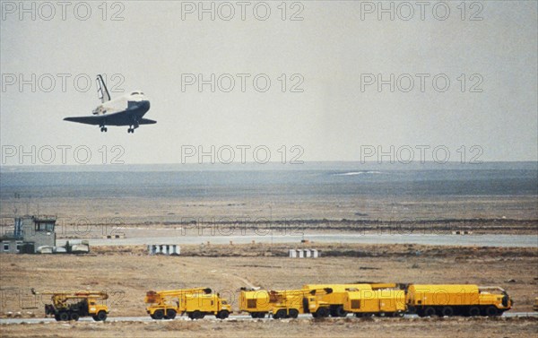 Soviet space shuttle buran landing at the yubileiniy airfeild at baikonur in kazakhstan, ussr after an unmanned test flight, november 1988.