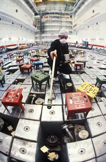 Technician in one of the reactors of the chernobyl nuclear power plant testing for high levels of radiation after the accident in april of 1986, may 1986.