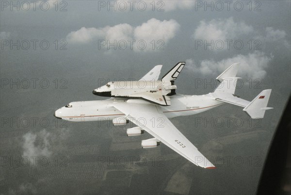 The antonov-225 mriya super-heavy transport aircraft conducting its first flight carrying the soviet space shuttle, buran, may 1989.