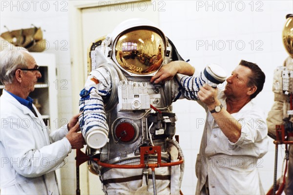 Assemblers at a recently de-classified aerospace facility ivan volchenkov and nikolay petrov with one of several newly designed spacesuits to be delivered to the mir space station, 1992.