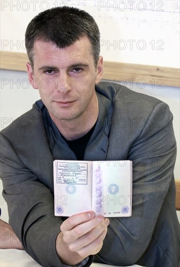 Krasnoyarsk territory, russia, july 20, 2009, mikhail prokhorov, polyus gold (polyus zoloto) chairman, and onexim (oneksim) group president, displays his passport to confirm that he now has the official residential registration in yeruda settlement.