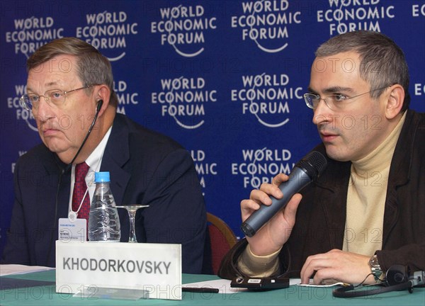 Moscow, russia, october 3, 2003, (l-r) exxon mobil's chairman lee raymond and yukos ceo mikhail khodorkovsky taking part in the work of moscow session of world economic forum on friday, where khodorkovsky declared that unification of two russian oil giants yukos and sibneft had been practically completed, exxon mobil expressed intention to buy 40-persent shares of 'yukos-sibneft' for 25 billion dollars.
