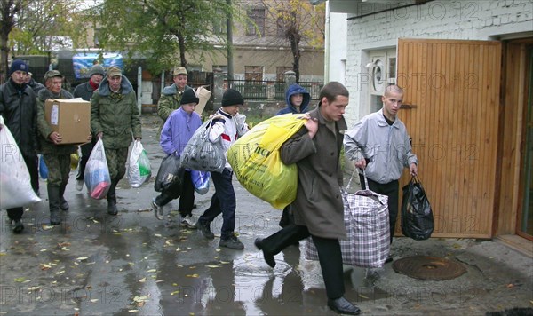 Chelyabinsk region, russia, october 29, 2003, inmates of the orphanage in the town of kopeisk (the ural area) and students of the chelyabinsk military automobile institute, which supports the orphanage, carrying bags with warm coats for children, under the order of the russian president the orphanage was subsidized with 1,200 thousand roubles (about 400,000 $).