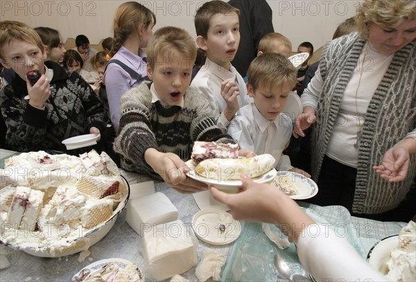 Nizhni novgorod,russia, december 17, 2003, children from orphanage no,23 taste with great pleasure a huge 200kg ice-cream in a shape of a castle which was presented to them as a gift by cooks of the local restaurant.