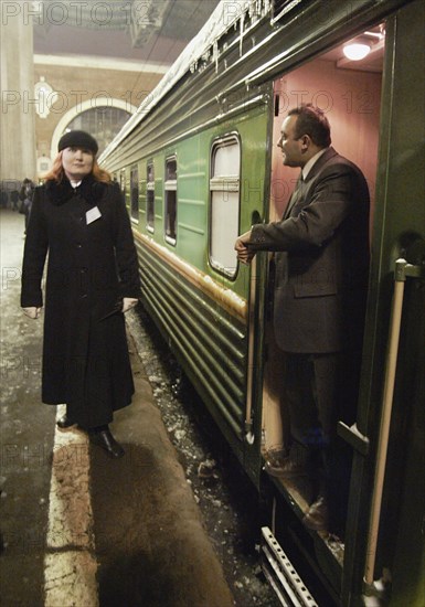 Moscow, russia, january 21, 2004, conductor margarita matveeva (l) stands near her new car of the luxury class of the 'tatarstan' train ready for leaving for kazan from kazan railway station of moscow.