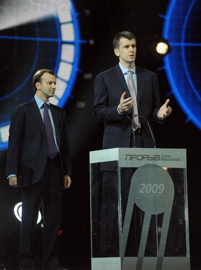 Moscow, russia, december 18, 2009, presidential aide arkady dvorkovich (l) looks on as chairman of the board of directors in polyus zoloto oao (ojsc polyus gold) and onexim group ceo mikhail prokhorov speaks at the first all-russian winners forum at the olympiysky arena.