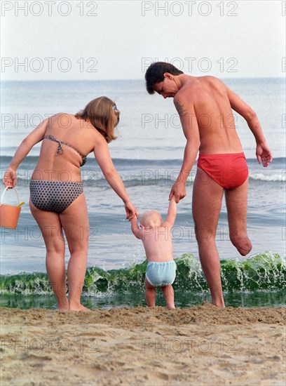 Krasnodar krai, at a rehabilitation center for soldiers-internationalists, a disabled war veteran and his family on the beach, september 1989.