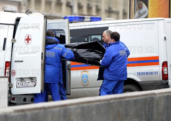Moscow, russia, march 29, 2010, rescue workers carry the body of a bombing victim into an ambulance outside park kultury metro station, sokolnicheskaya line of the moscow underground, an explosion rocked the metro station at 8,40 during the rush hour killing more than ten passengers.