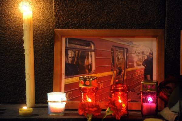Moscow, russia, march 30, 2010, a photograph of a damaged metro carriage and candles to commemorate victims of the metro bomb explosions, blasts rocked two stations on sokolnicheskaya line of the moscow underground during the rush hour killing 38 and injuring over 60 passengers.