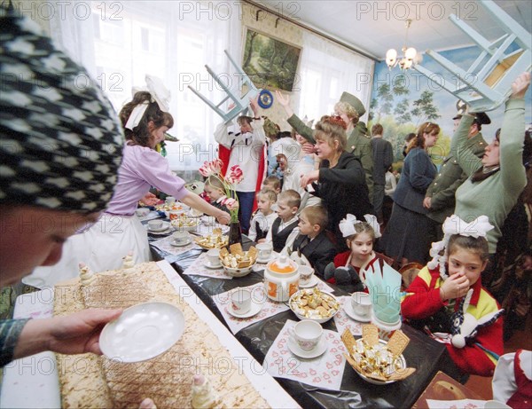 Ivanovo region, russia, june 7, 2004, llnmates of the local 3/3 women's colony and children from local orphanages pictured during a joint party as there is a practice that women prison inmates meet with orphans and show care about them, cooking treats and staging perfomances for the kids.