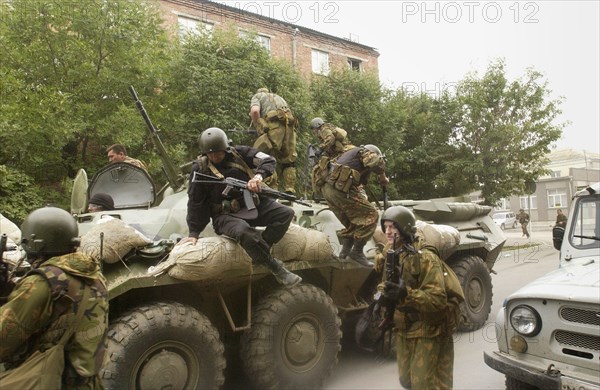 Special forces soldiers take position at a seized school in beslan, north ossetia, friday, sept, 3, 2004, commandos stormed a school friday in southern russia where hundreds of hostages had been held for three days.
