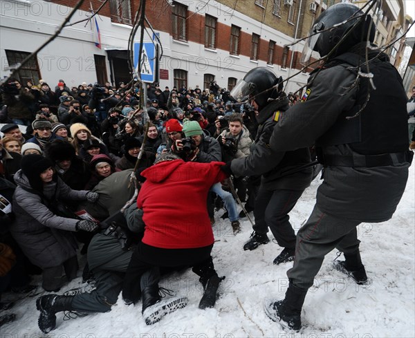 Moscow, russia, december 27, 2010, riot police scuffle with a demonstrator during a rally of khodorkovsky's supporters outside the khamovniki district court, the court is expected to issue its ruling on the second case against former yukos boss mikhail khodorkovsky and former menatep bank chief platon lebedev, the two men have been found guilty of stealing more than 200m tonnes of oil from yukos subsidiaries.