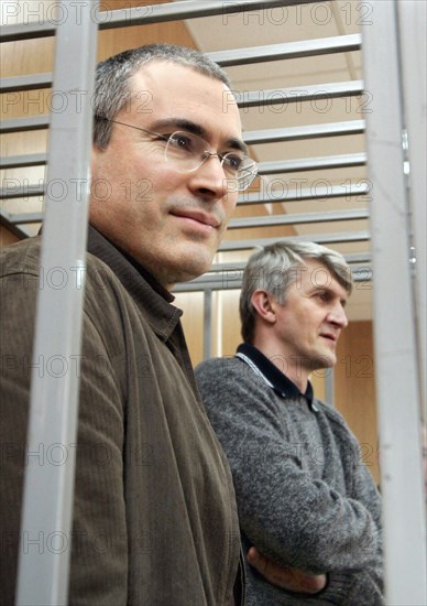 Moscow, russia, march 28, 2005, former yukos ceo mikhail khodorkovsky (l) and his partner platon lebedev stand behind bars as they listen to a prosecutor during their trial in moscow, monday, march 28, 2005, prosecutor dmitry shokhin stated that analysis of the evidence collected has made it possible to draw an 'unambiguous and categorical conclusion' that former yukos head mikhail khodorkovsky and menatep leader platon lebedev indeed committed the alleged crimes.
