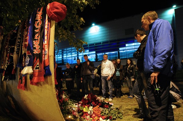 Yaroslavl, russia, september 8, 2011, lokomotiv yaroslavl fans commemorate players of a khl ice hockey team lokomotiv who died in a yak-42 passenger plane crash on september 7 by laying flowers and lighting candles at the arena-2000 stadium.