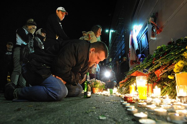 Yaroslavl, russia, september 8, 2011, lokomotiv yaroslavl fans commemorate players of a khl ice hockey team lokomotiv who died in a yak-42 passenger plane crash on september 7 by laying flowers and lighting candles at the arena-2000 stadium.