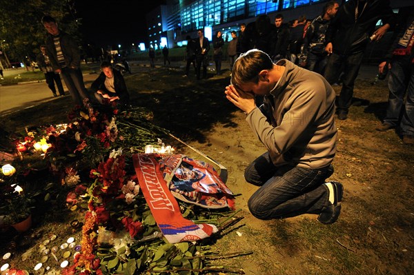 Yaroslavl, russia, september 8, 2011, lokomotiv yaroslavl fans commemorate players of a khl ice hockey team lokomotiv who died in a yak-42 passenger plane crash on september 7 by laying flowers and lighting candles at the arena-2000 stadium.