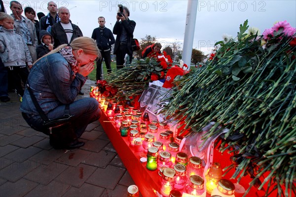 Minsk, belarus, september 9, 2011, people lay flowers and light candles outside minsk-arena stadium to commemorate hc lokomotiv yaroslavl team players who died in a plane crash on september 7, a khl game lokomotiv vs, dinamo minsk was due to take place here on september 8.