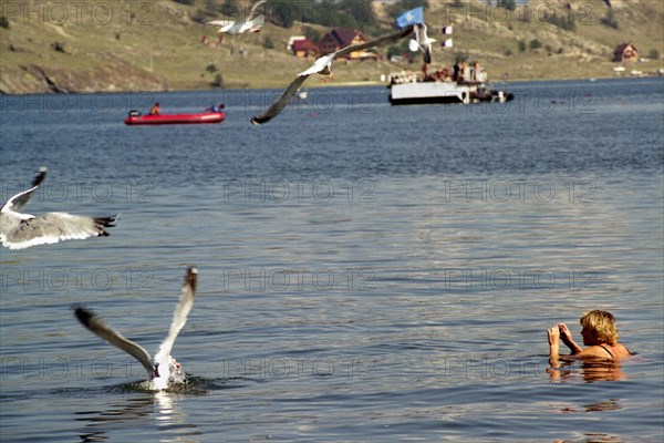 Irkutsk region, russia, a woman swimming in lake baikal, the world's deepest lake, august 2005.