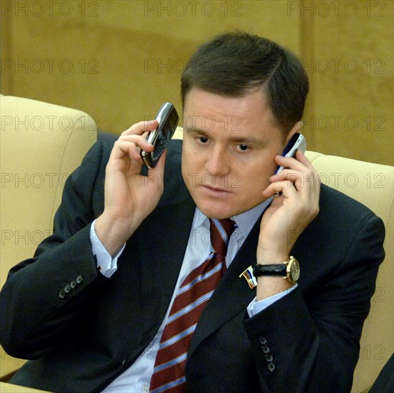 Moscow, russia, september 14, deputy chairman of the committee on civil, criminal, arbitral and procedural law vladimir gruzdev talks over cell phones during a plenary session of the russian state duma.