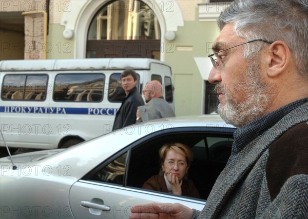 Moscow, russia, october 6, 2005, alexander osovtsov (r) and irina yasina (inside the car), project managers at the open russia charitable foundation, whose chairman is mikhail khodorkovsky, pictured outside the foundation's office where investigators from the russian prosecutor general's office seized documents during a search.