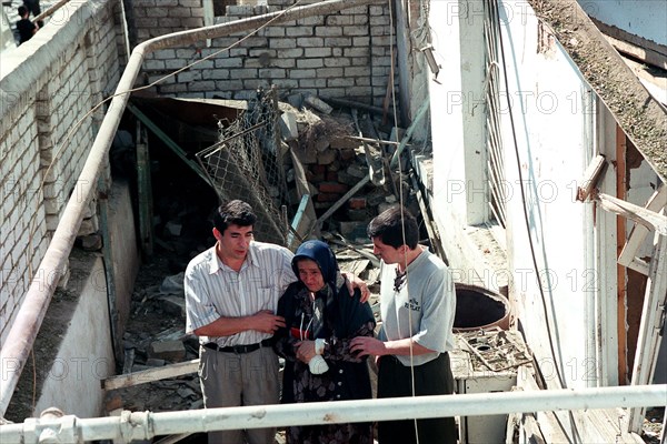 Makhachkala, russia, september 7, 1999, rescue workers pictured rendering help to an old woman at the place of accident as the death toll from a blast in a 5-storey dwelling house in the daghestani town of buinaksk occurred on sept,4, has reached 61, however, this figure is not final as the clearing the debris is still in progress, the list of casualties includes 21 children and 18 women, ten victims have not yet been identified, altogether 145 people were injured by the blast.