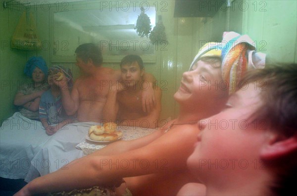 A father and his sons wash up in a russian sauna (banya) built by themselves, the karelovs organized a family-style orphanage for 11 children in a village of zavolzhsky district, 2005.