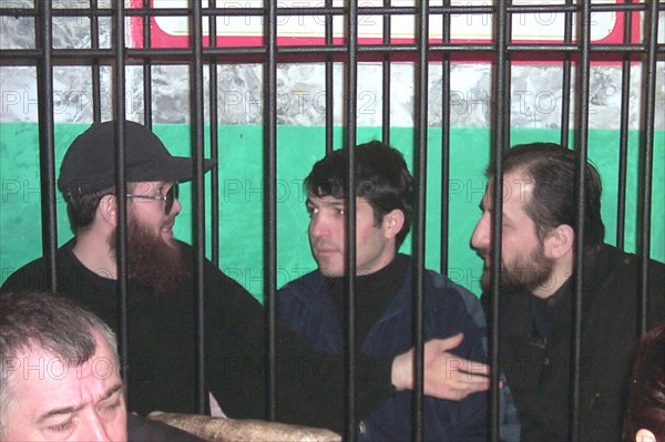 Makhachkala, dagestan, russia, december 5, 2001, salman raduyev (left) and his supporters on terrorism charges pictured on wednesday behind the bars at the courtroom, after witnesses and survivors of their crimes gave testimonies, now the court will consider written witnesses' testimonies of those who were not able to come in person.