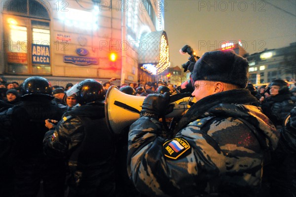 Moscow, russia, december 5, 2011, a police officer with a megaphone at an opposition protest in central moscow against alleged vote-rigging in the december 4 parliamentary election.