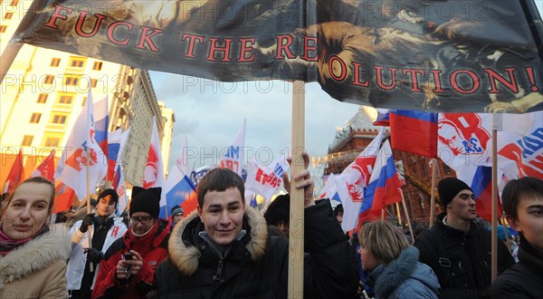 Moscow, russia, december 12, 2011, young demonstrators carry a placard reading fuck the revolution! during a rally staged by pro-kremlin youth groups in central moscow, the event took place two days after a mass protest against alleged vote rigging in the 4 december parliamentary election.