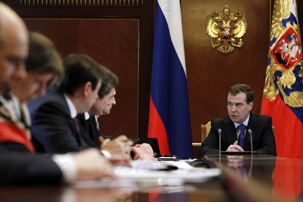 Moscow region, russia, december 13, 2011, president of russia dmitry medvedev (background) holds a meeting with officials from the government, presidential administration and the expert community to discuss the delimitation of powers between the bodies of authority, at gorki residence.