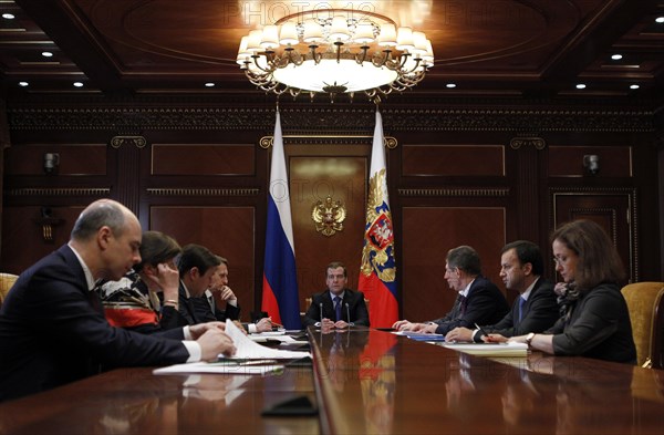Moscow region, russia, december 13, 2011, president of russia dmitry medvedev (background) holds a meeting with officials from the government