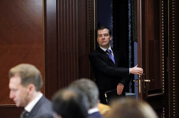 Moscow region, russia, december 13, 2011, president of russia dmitry medvedev (background) arrives for a meeting with officials from the government, presidential administration and the expert community to discuss the delimitation of powers between the bodies of authority, at gorki residence.