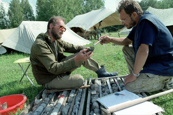 Chief of the bashkir geologic party i,andreyev (l) and geologist a, burdakov examining samples of boring at the kalkanovsky chromium ore field in uchaltinsky district of bashkiria in the transural region famous for the prospected mineral resourses,the the chromium field was prospected by the geologists of the 'bashkir institute of mineral raw materials', august 1999.