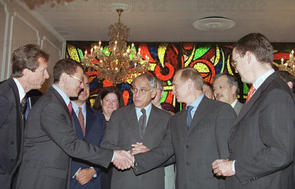New york, usa, september 9, 2000, russian president vladimir putin shaking hands with chief of the tyumen oil company, or tnk, semyon kukes, at the signing of an accord by the tnk and the u,s, export-import bank, on friday, the accord was signed at the russian mission in the united nations, putin could attended the ceremony as he was in new york city on the occasion of the u,n, millennium summit.