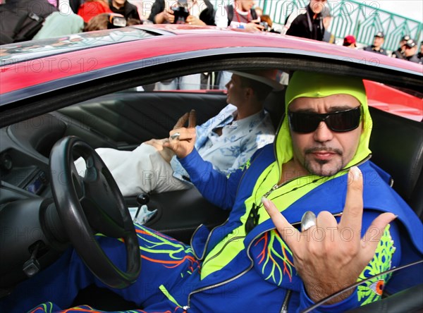 Bogdan titomir, dubbed 'the first russian rapper', gives the heavy-metal sign for victory as he sits in his car near the olympic sports complex, the venue of the 2006 muz-tv awards, prior to the ceremony, june 2, 2006.
